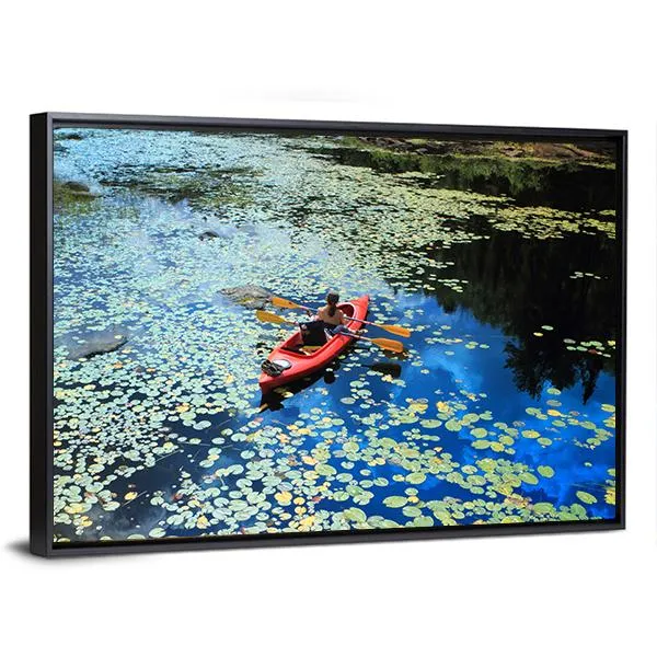 Canoeing In Water Lilies Canvas Wall Art