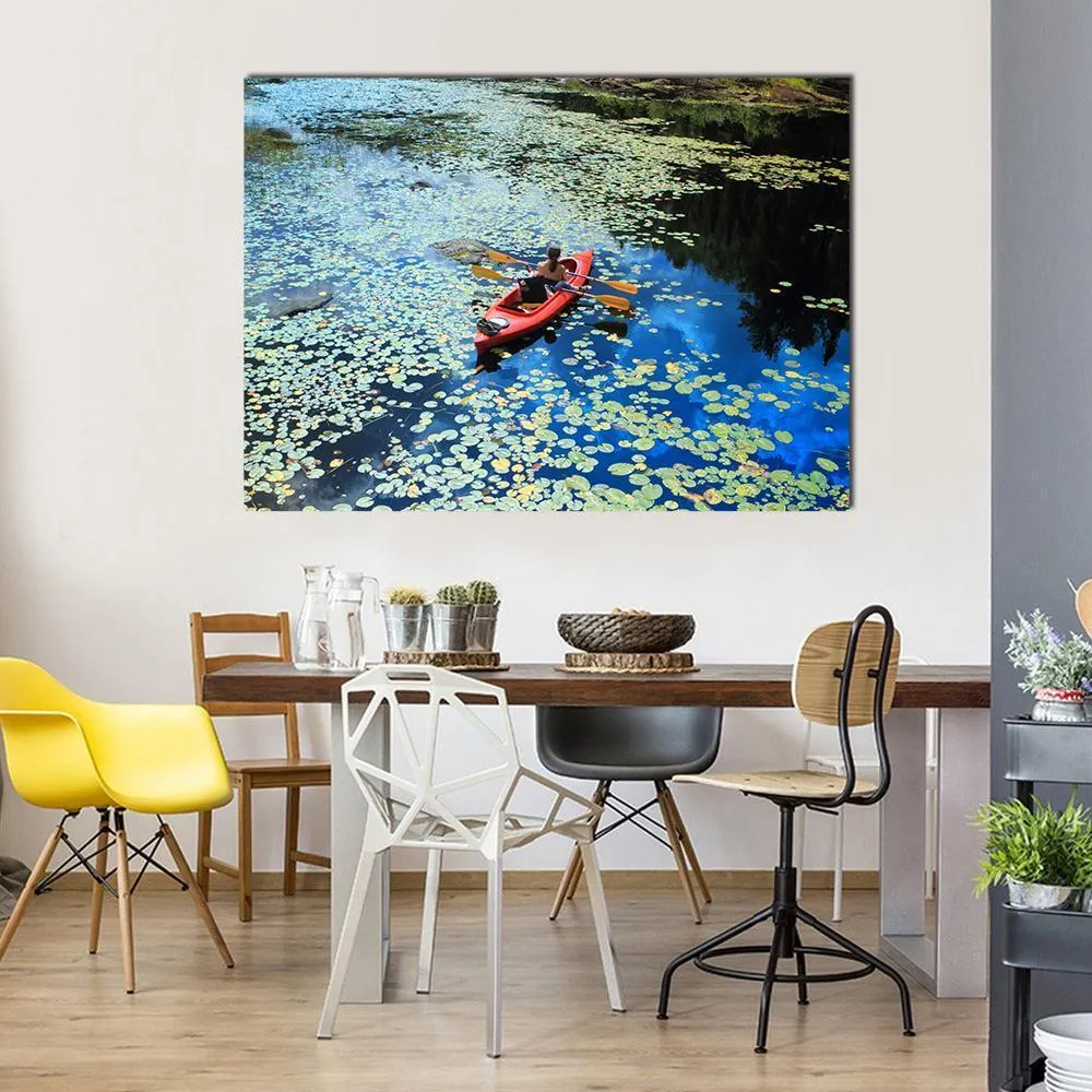 Canoeing In Water Lilies Canvas Wall Art